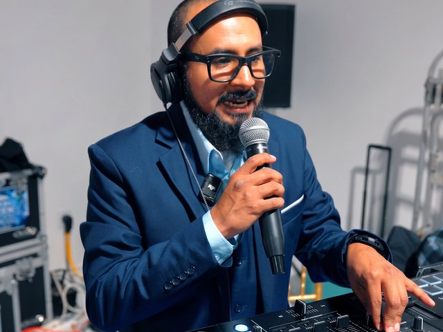 Uri in headphones on the microphone at the controller